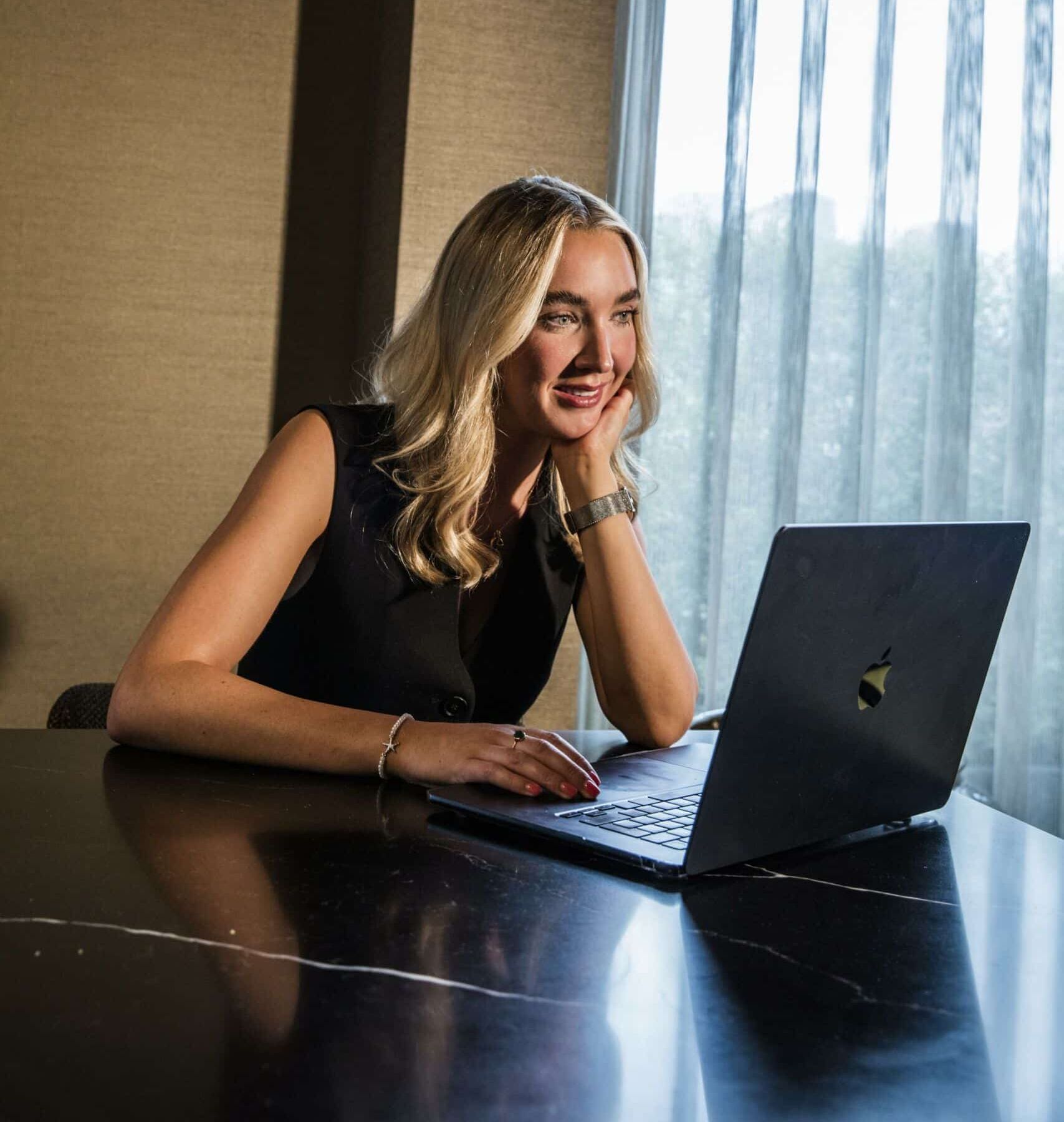 woman smiling at a laptop